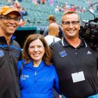 Two people at Comerica Park with a camera man